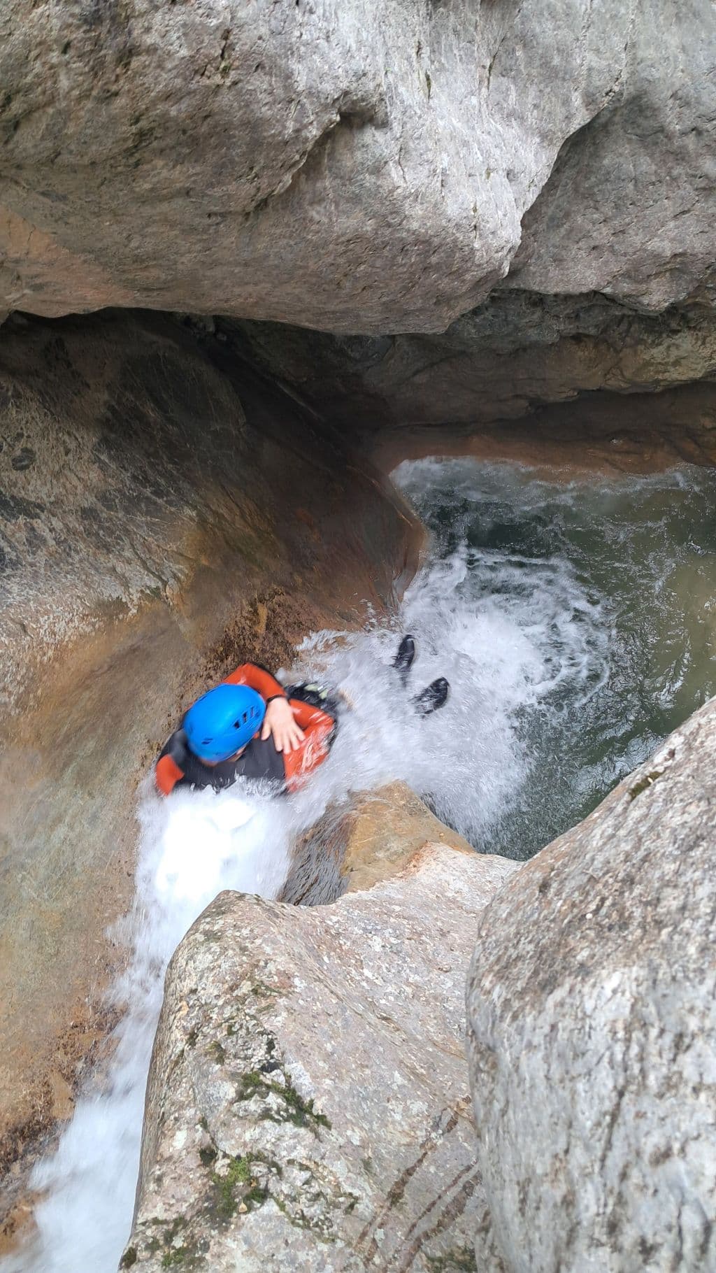 Canyoner abseiling down a waterfall in the Viu de Llevata canyon, Spanish Pyrenees.